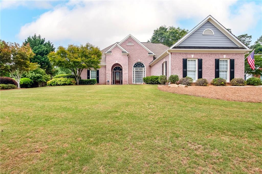 2800 Inverness Way Monroe, GA 30656 - Photo 1 of 1 a front view of a house with a yard and garage