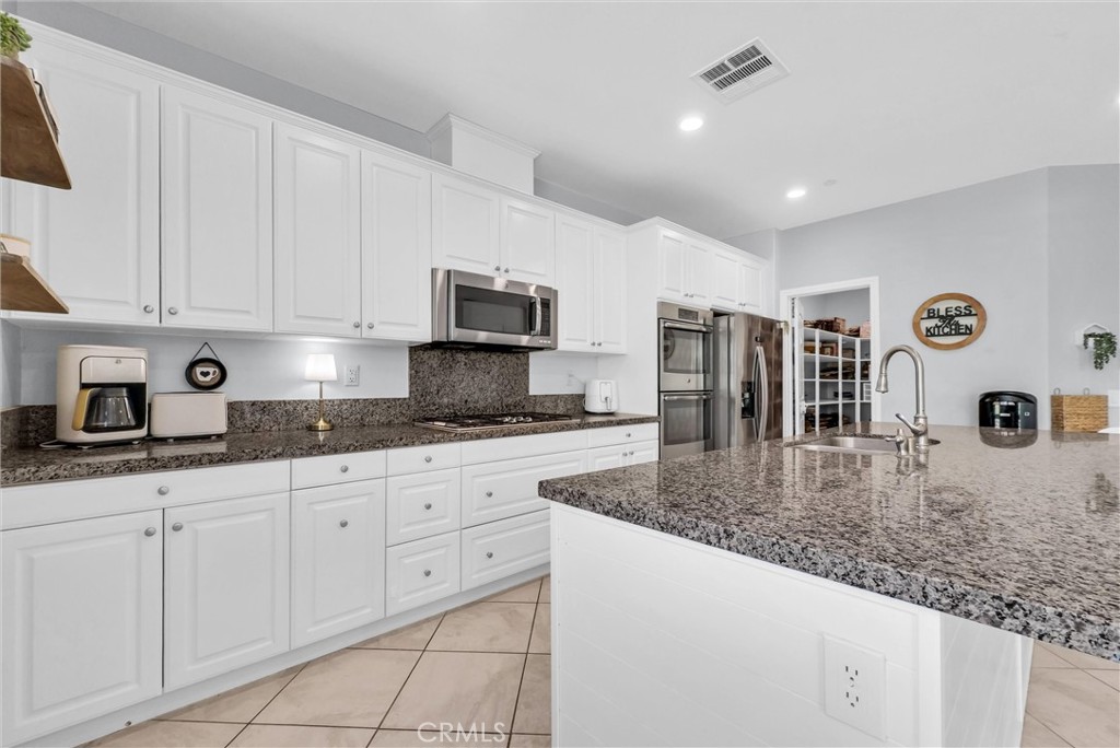 37656 Needlegrass Road Murrieta, CA 92563 - Photo 8 of 29 With cabinet space to spare, you can store all your kitchen ware here.