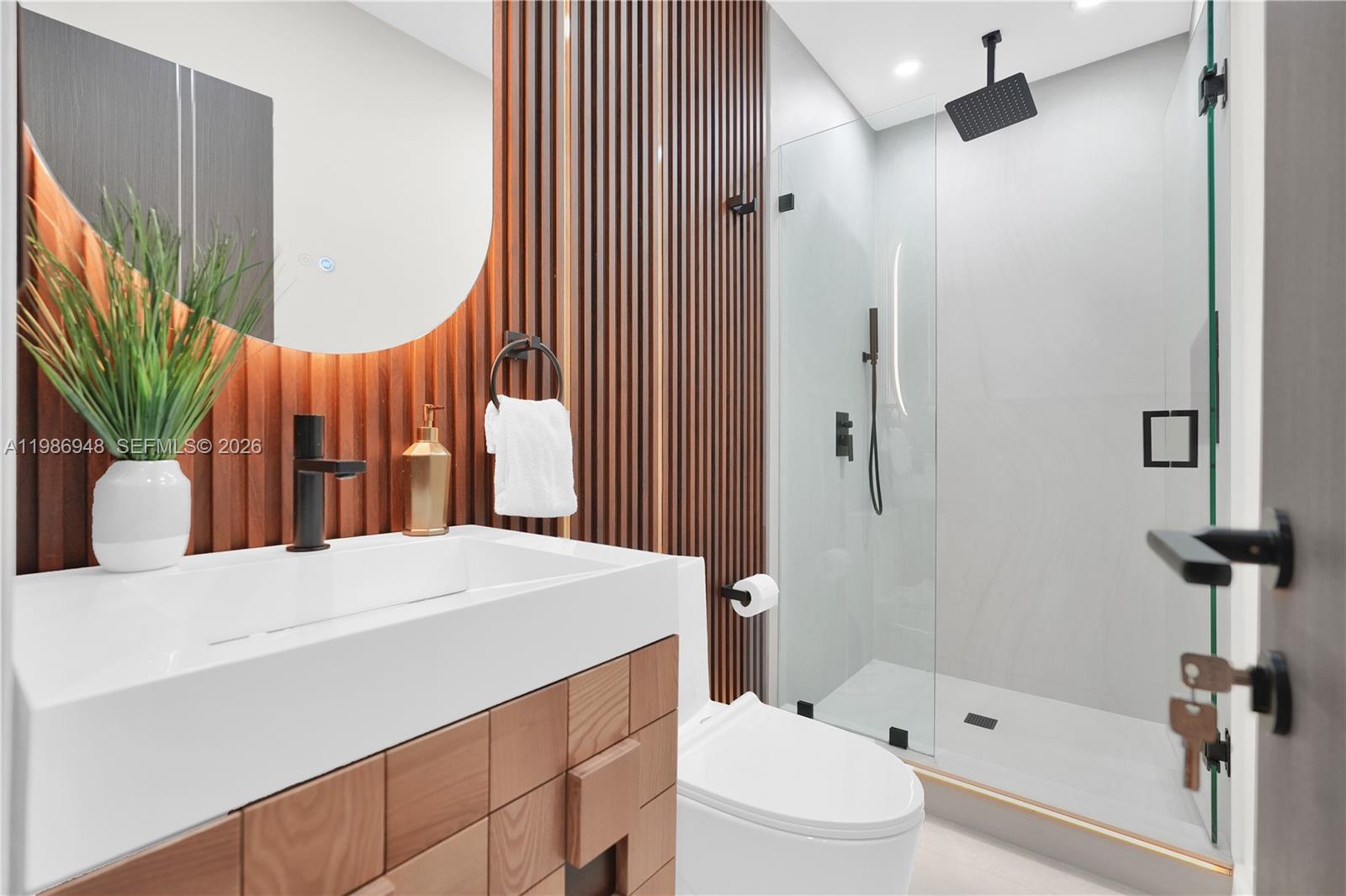 8220 Southwest 133rd Street Pinecrest, FL 33156 - Photo 12 of 34 a bathroom with a sink toilet and shower