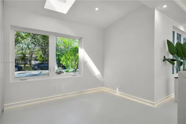 a bedroom with a bed next to a window