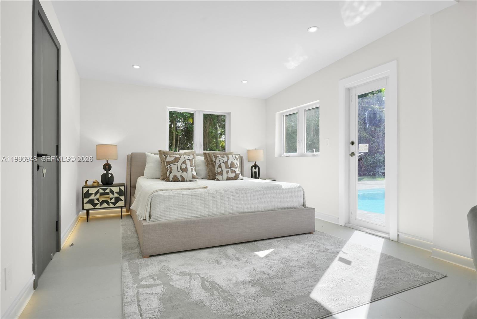 8220 Southwest 133rd Street Pinecrest, FL 33156 - Photo 15 of 34 a bedroom with a large bed and a couch