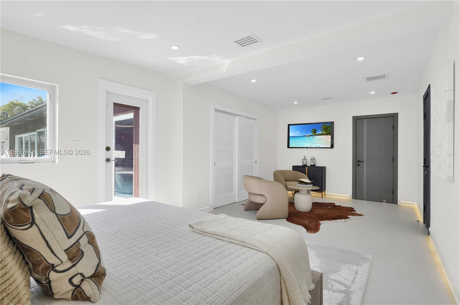 8220 Southwest 133rd Street Pinecrest, FL 33156 - Photo 16 of 34 a bedroom with a bed next to a window