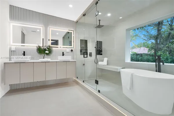 a spacious bedroom with a bed and a flat screen television