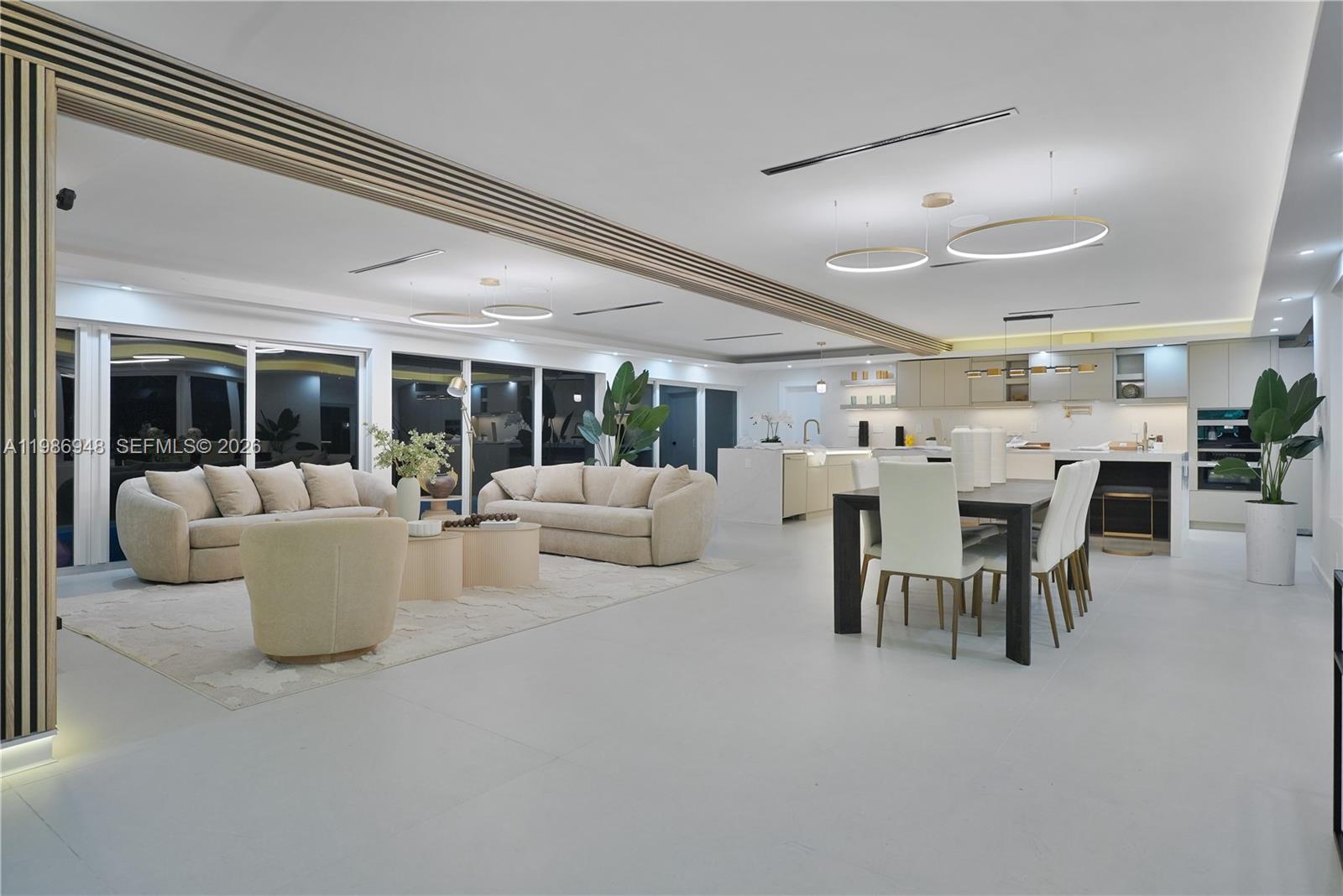 8220 Southwest 133rd Street Pinecrest, FL 33156 - Photo 2 of 34 a living room with furniture and a large window