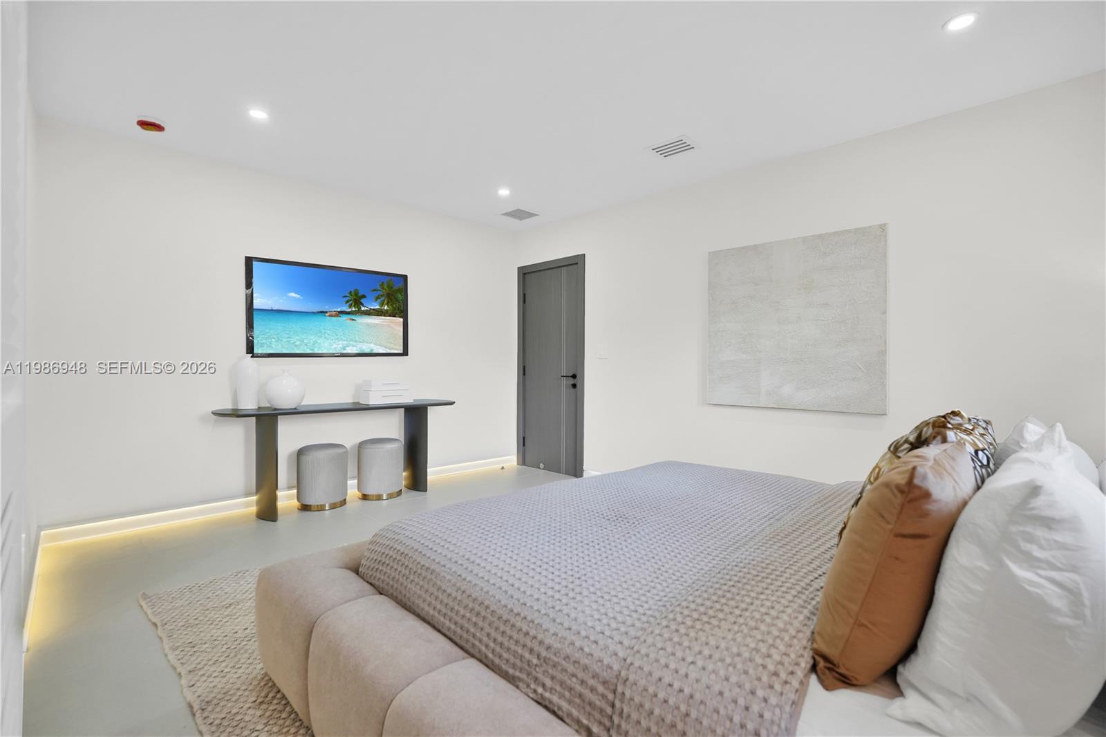 8220 Southwest 133rd Street Pinecrest, FL 33156 - Photo 21 of 34 a bedroom with a bed and a painting on the wall