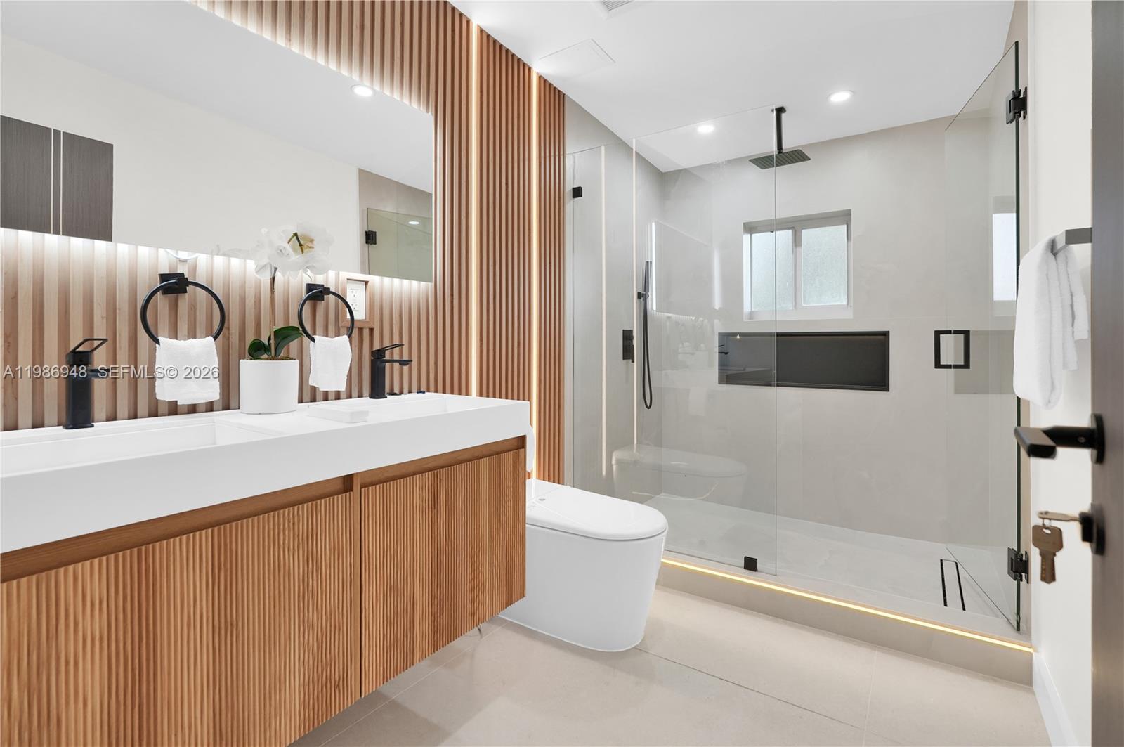 8220 Southwest 133rd Street Pinecrest, FL 33156 - Photo 22 of 34 a bathroom with a bathtub shower sink vanity and toilet