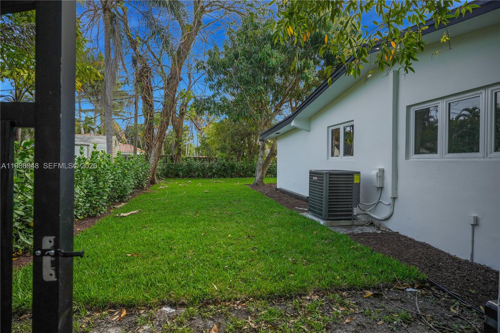 8220 Southwest 133rd Street Pinecrest, FL 33156 - Photo 29 of 34 a view of backyard of house with green space