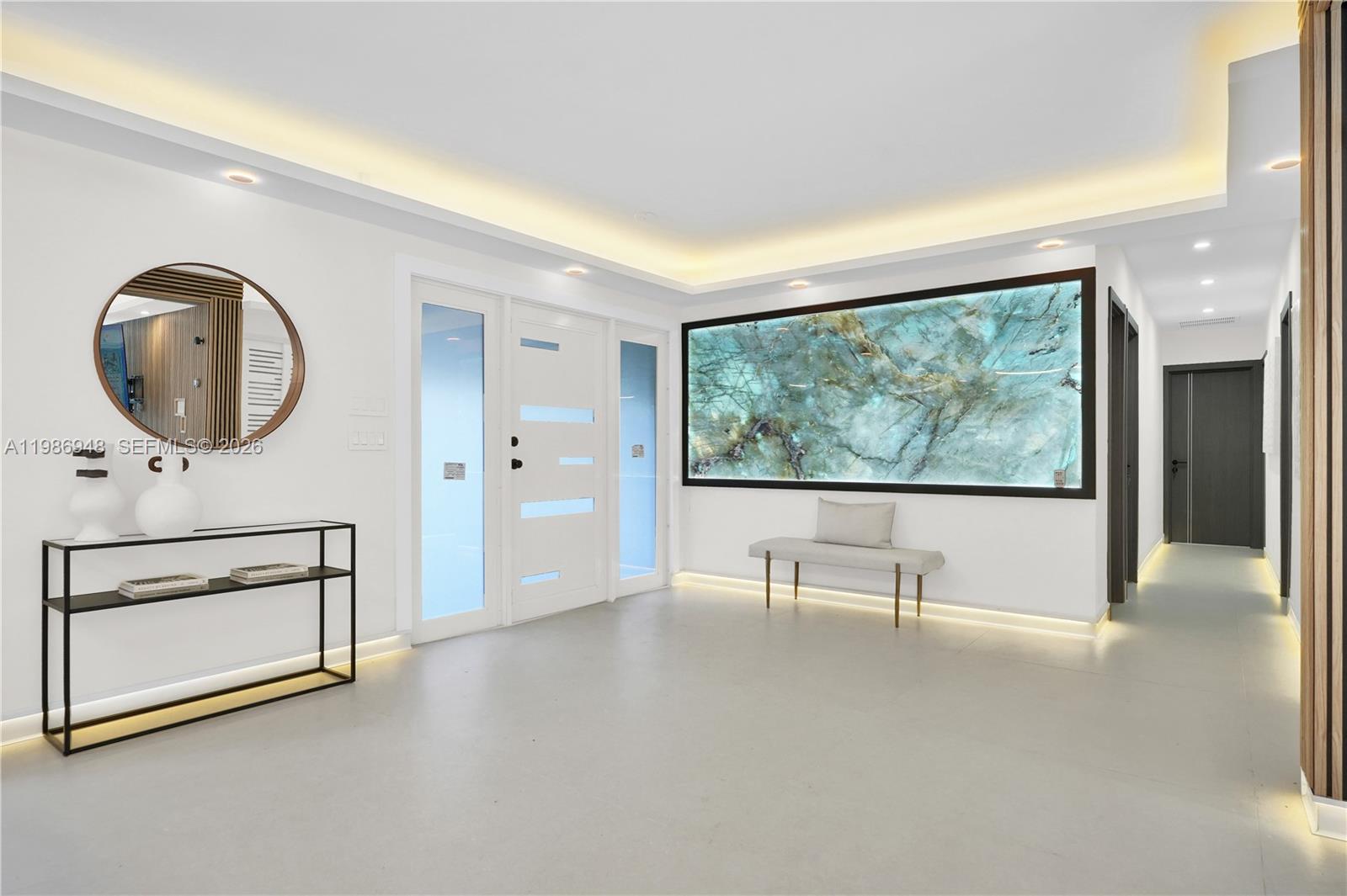 8220 Southwest 133rd Street Pinecrest, FL 33156 - Photo 3 of 34 an empty room with windows and fan