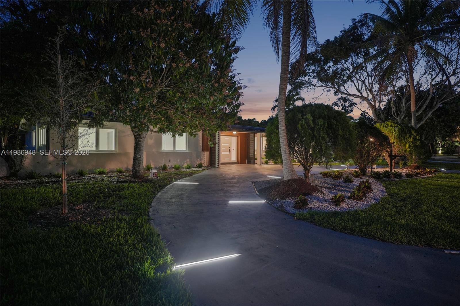 8220 Southwest 133rd Street Pinecrest, FL 33156 - Photo 31 of 34 a view of a street with a house in the background