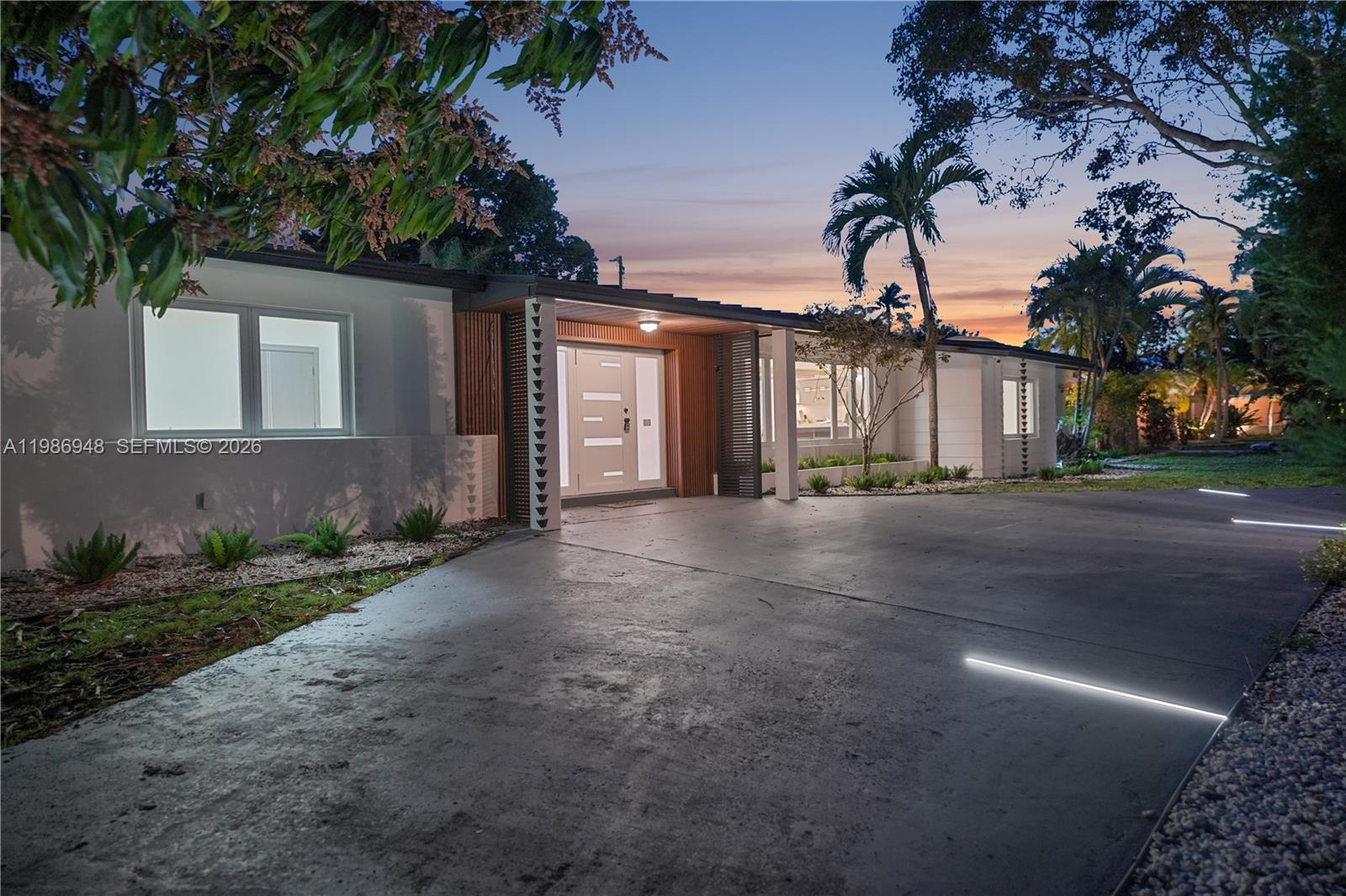 8220 Southwest 133rd Street Pinecrest, FL 33156 - Photo 32 of 34 a view of a house with a street