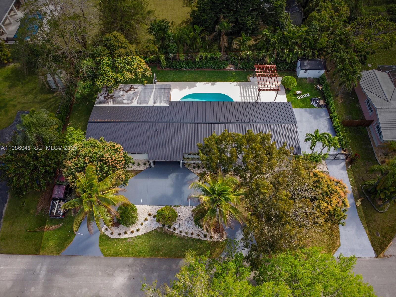 8220 Southwest 133rd Street Pinecrest, FL 33156 - Photo 34 of 34 an aerial view of a house with a yard basket ball court and outdoor seating