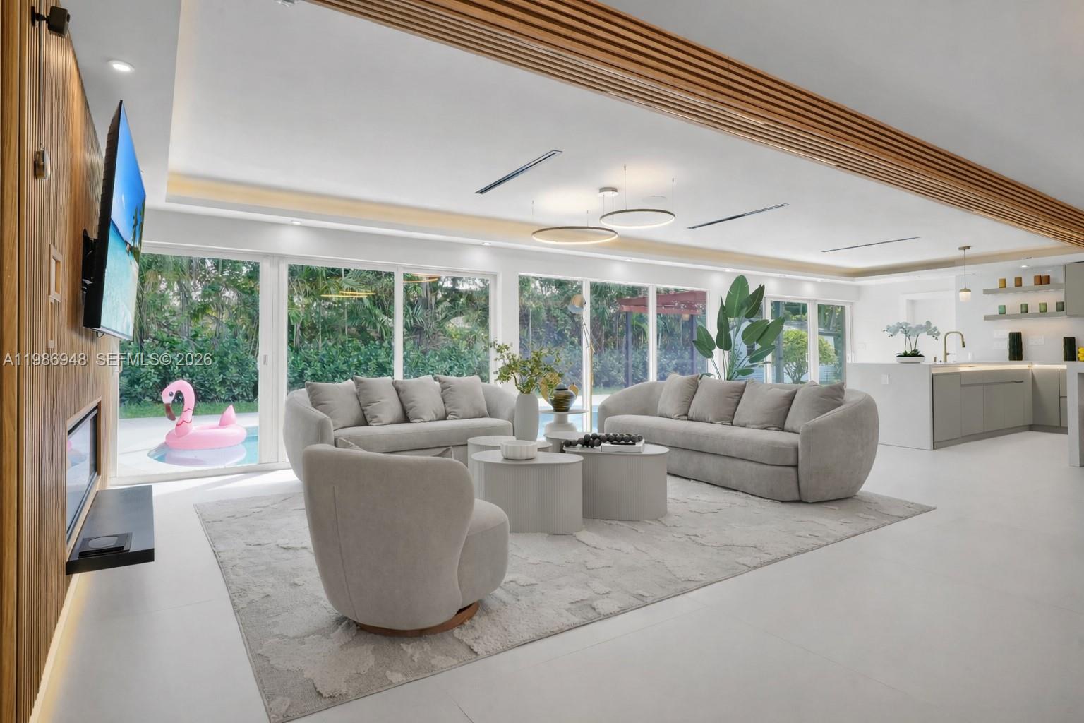 8220 Southwest 133rd Street Pinecrest, FL 33156 - Photo 4 of 34 a living room with furniture and large windows