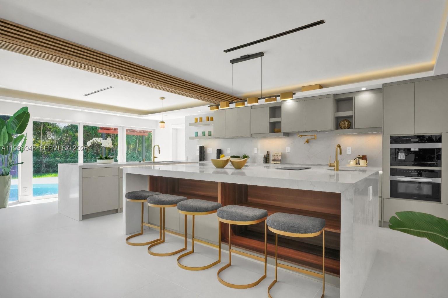 8220 Southwest 133rd Street Pinecrest, FL 33156 - Photo 9 of 34 a room with stainless steel appliances kitchen island granite countertop furniture and a floor to ceiling window