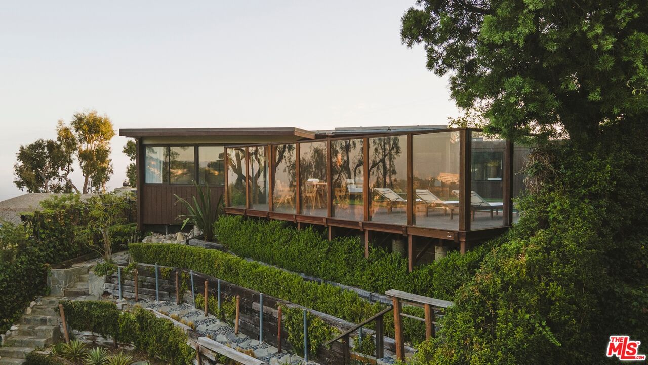 1438 North Kenter Avenue Los Angeles, CA 90049 - Photo 1 of 1 a balcony with trees in front of it