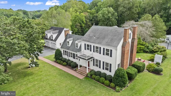 a aerial view of a house with pool and plants