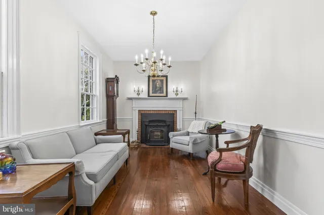 a view of a dining room with furniture a chandelier and wooden floor