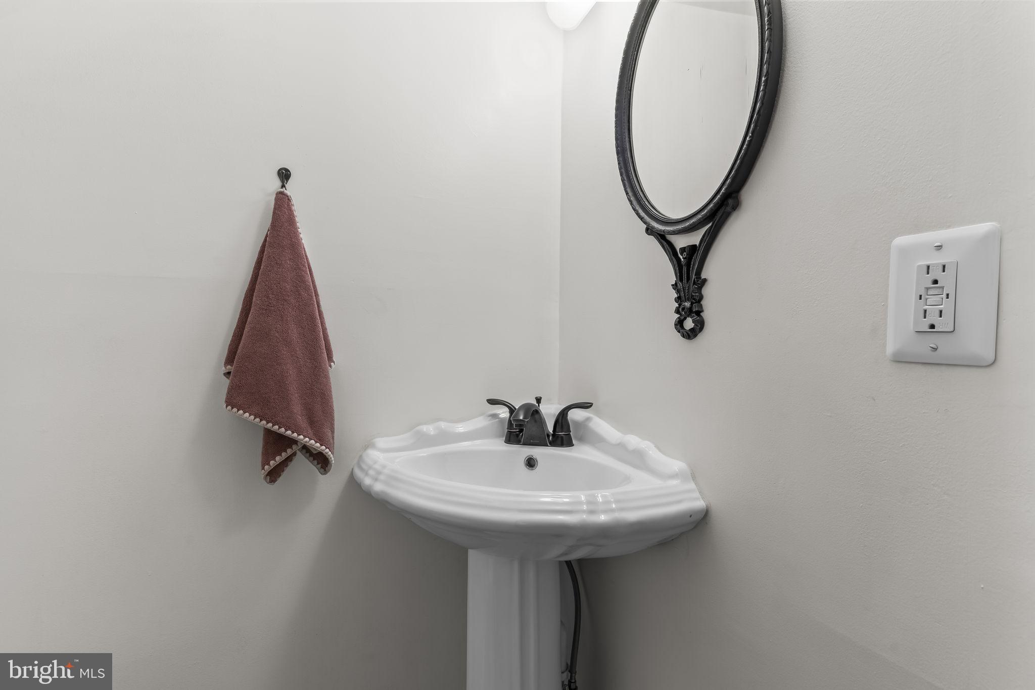 525 Small Reward Road Huntingtown, MD 20639 - Photo 18 of 67 a bathroom with a sink and a mirror