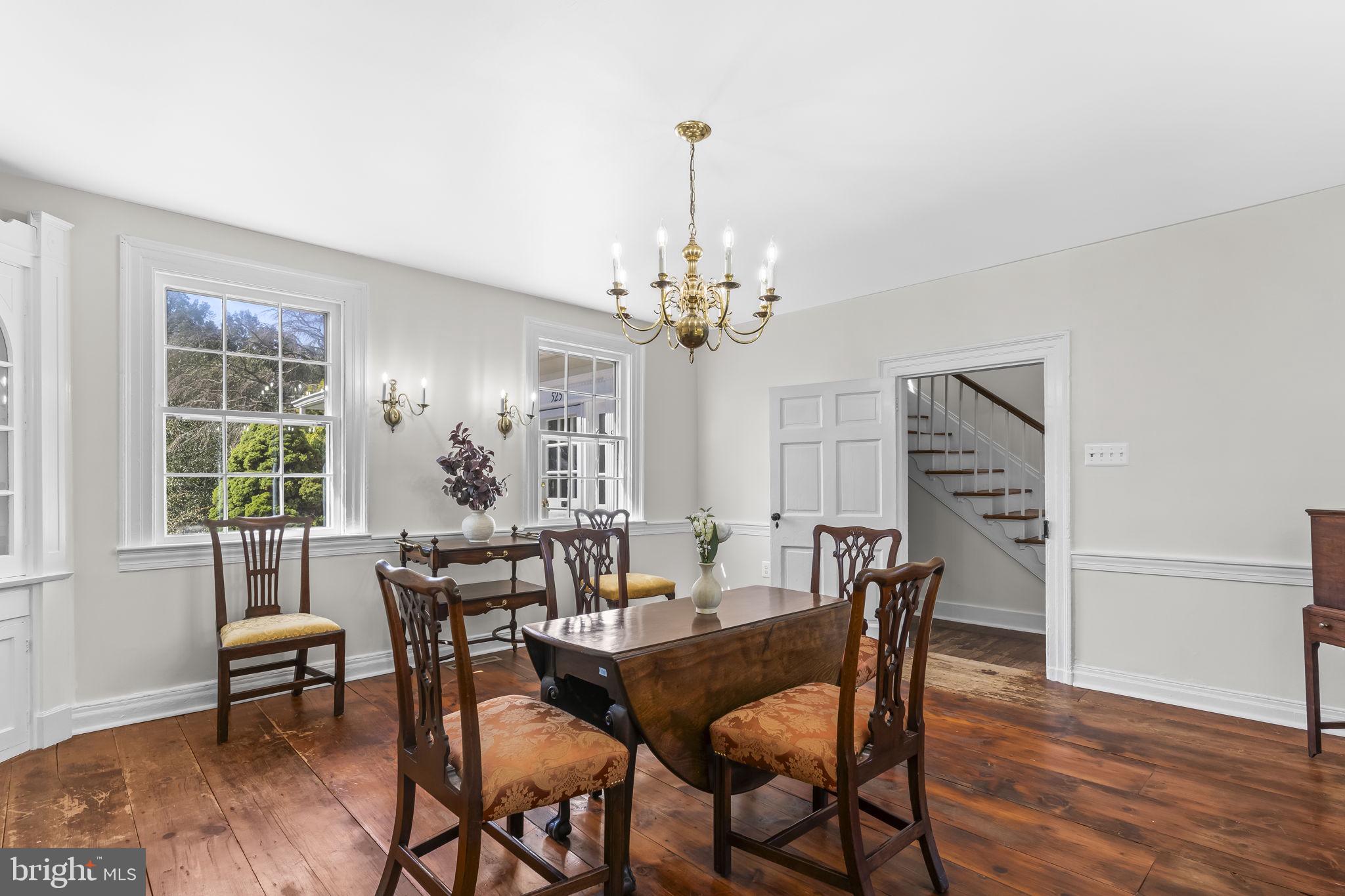 525 Small Reward Road Huntingtown, MD 20639 - Photo 19 of 67 a view of a dining room with furniture a chandelier and wooden floor