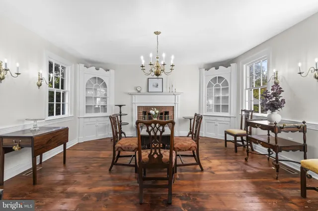 a view of a dining room with furniture a chandelier and wooden floor
