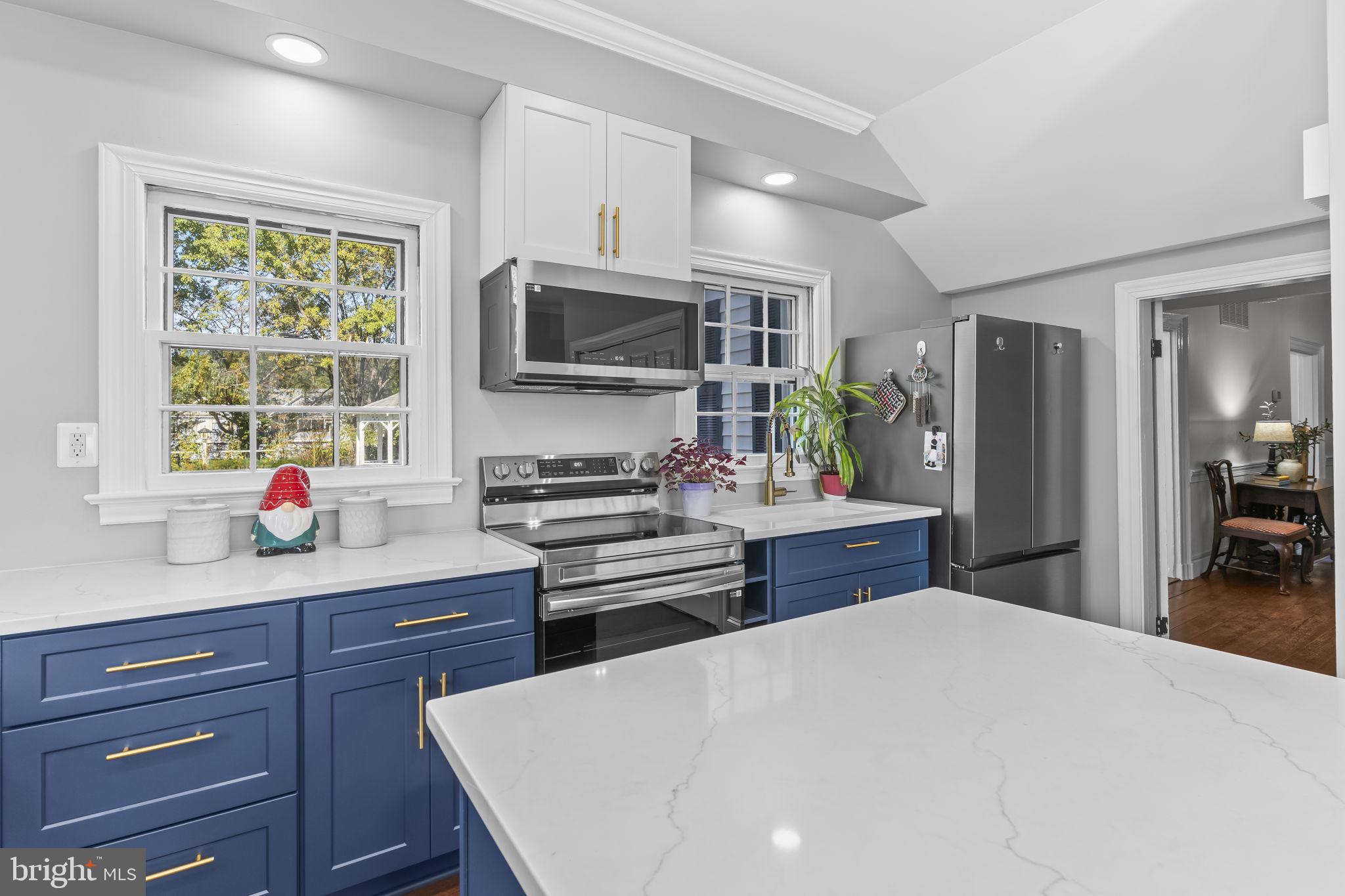 525 Small Reward Road Huntingtown, MD 20639 - Photo 21 of 67 a kitchen with stainless steel appliances a stove refrigerator sink and microwave