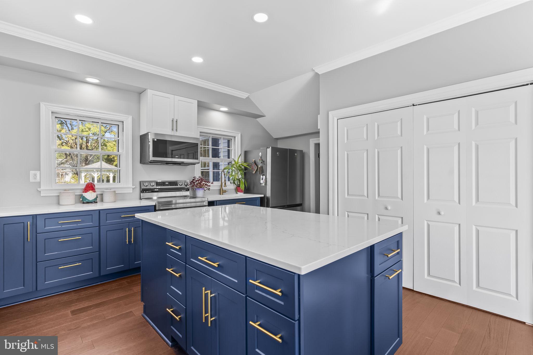 525 Small Reward Road Huntingtown, MD 20639 - Photo 24 of 67 a kitchen with a sink a stove a microwave and wooden cabinets