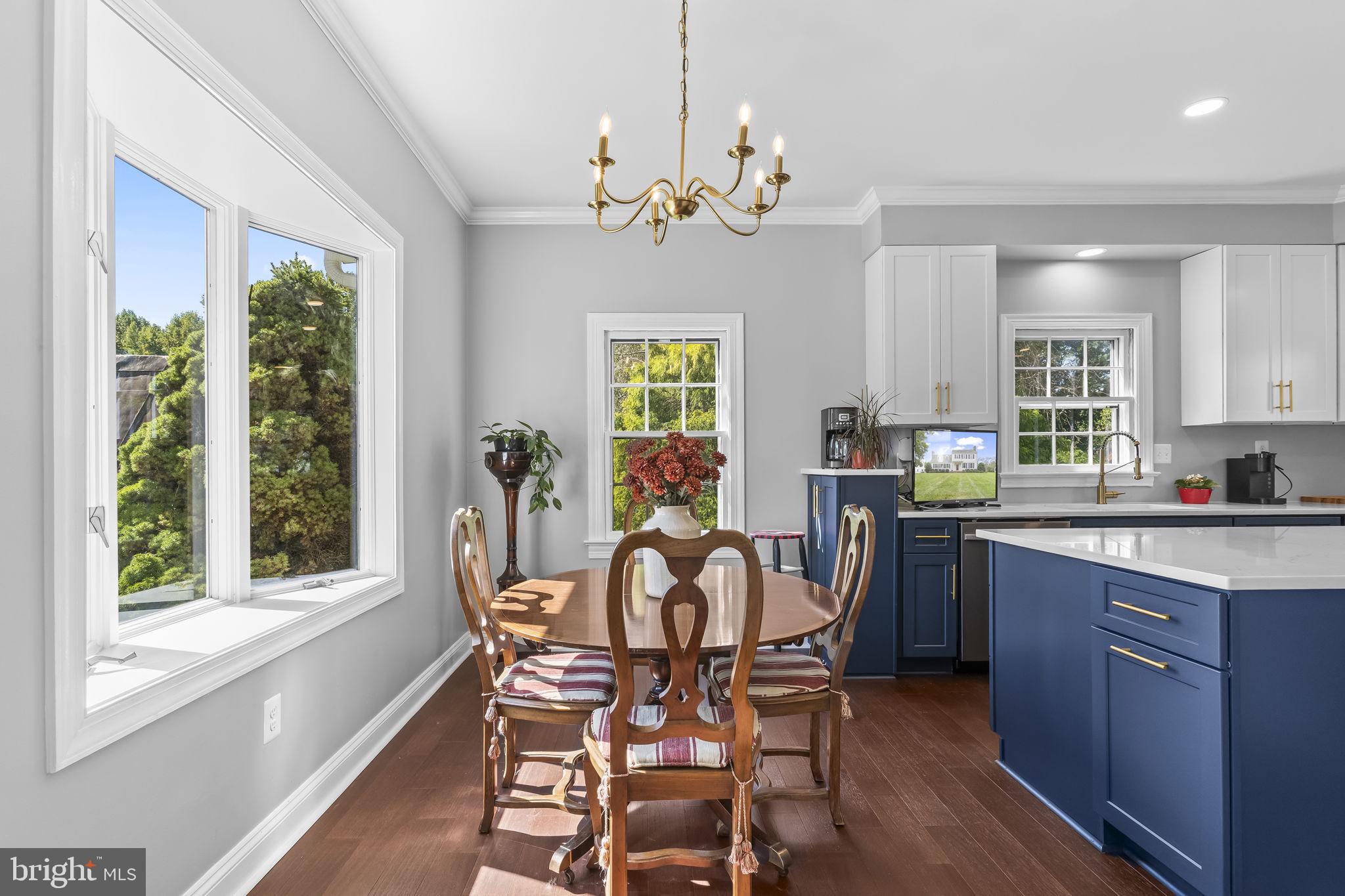 525 Small Reward Road Huntingtown, MD 20639 - Photo 25 of 67 a view of a dining room with furniture a chandelier and wooden floor