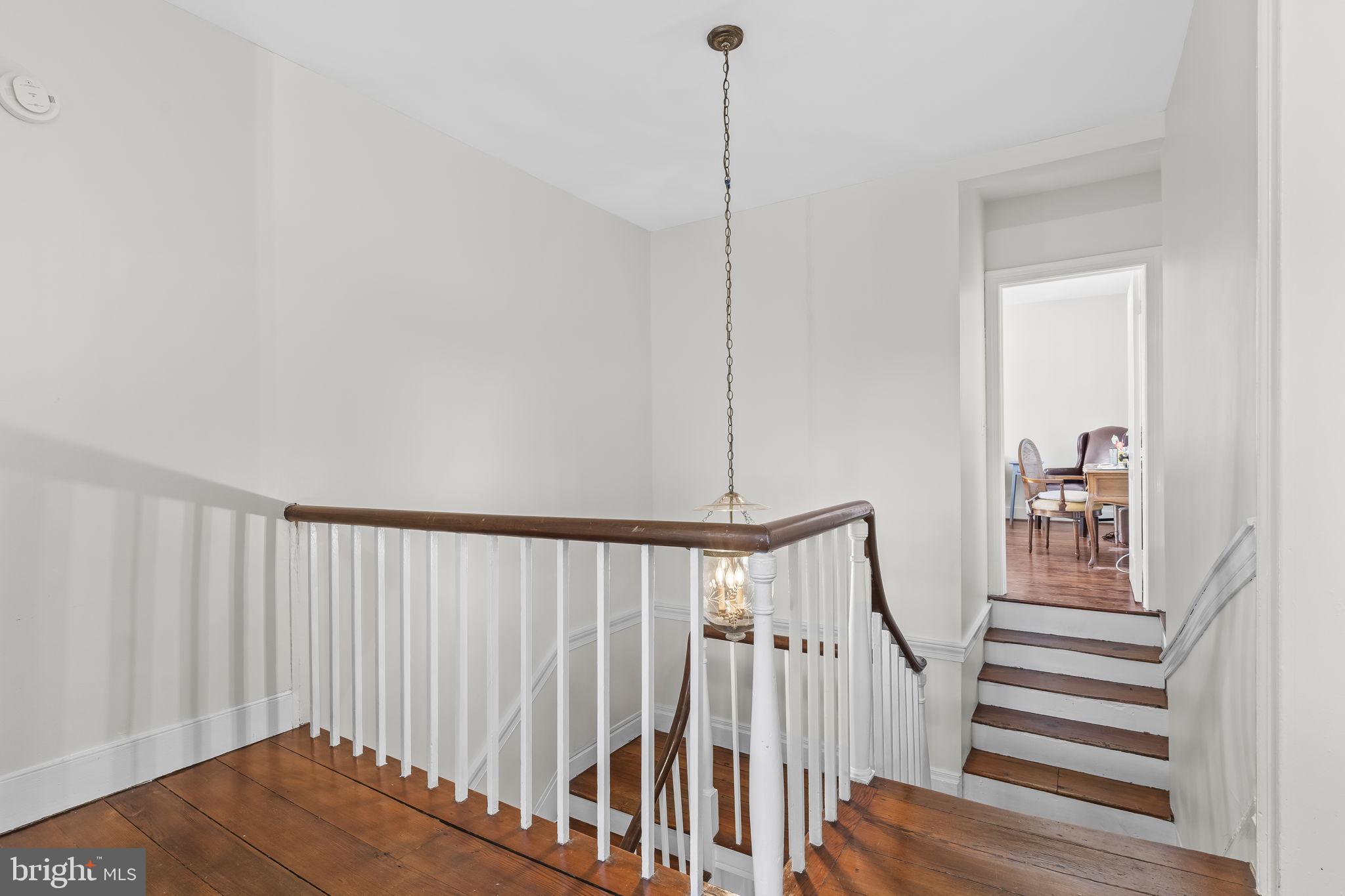 525 Small Reward Road Huntingtown, MD 20639 - Photo 27 of 67 a view of hallway with stairs and wooden floor