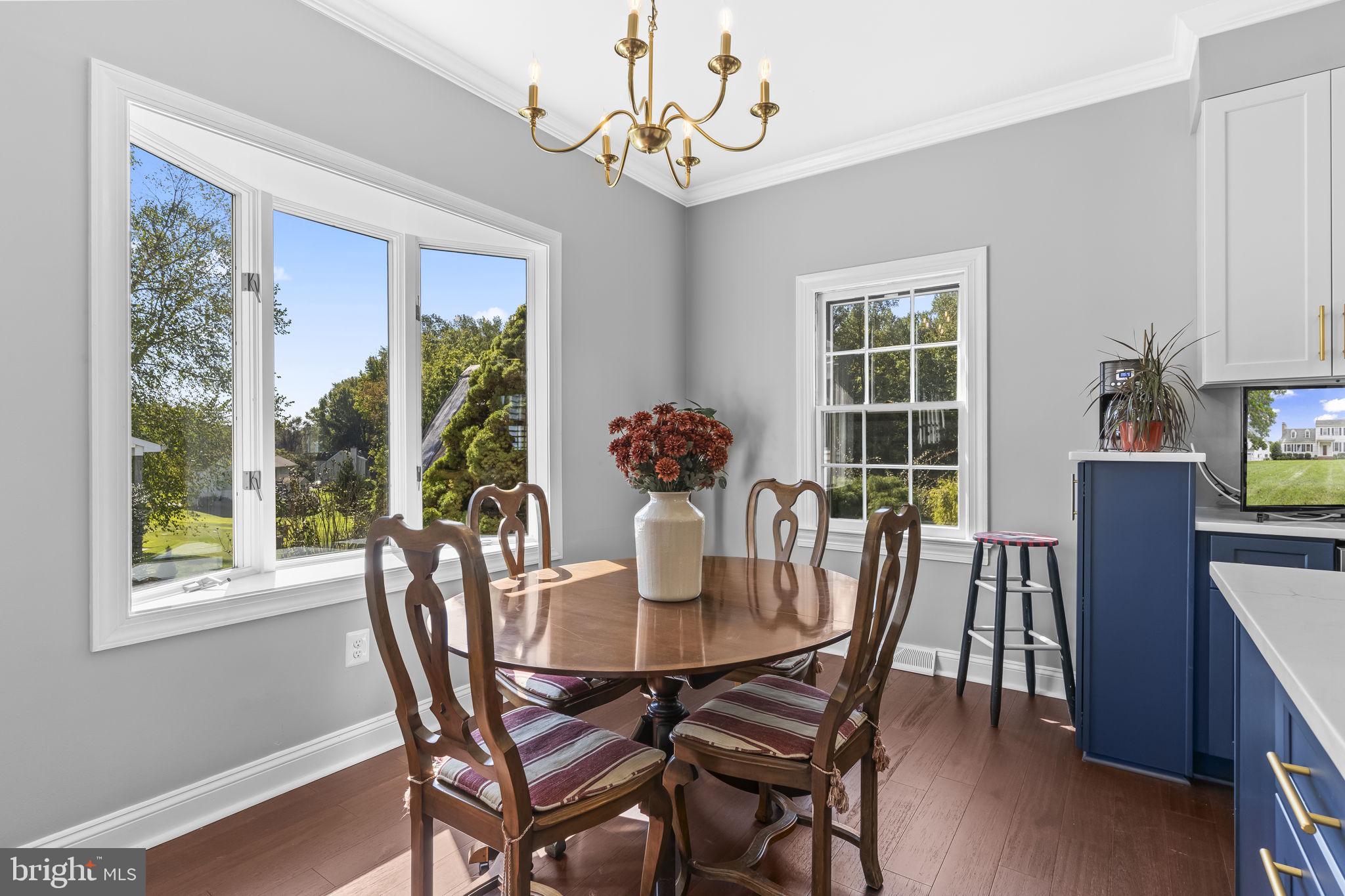 525 Small Reward Road Huntingtown, MD 20639 - Photo 27 of 67 a dining room with furniture potted plants and wooden floor