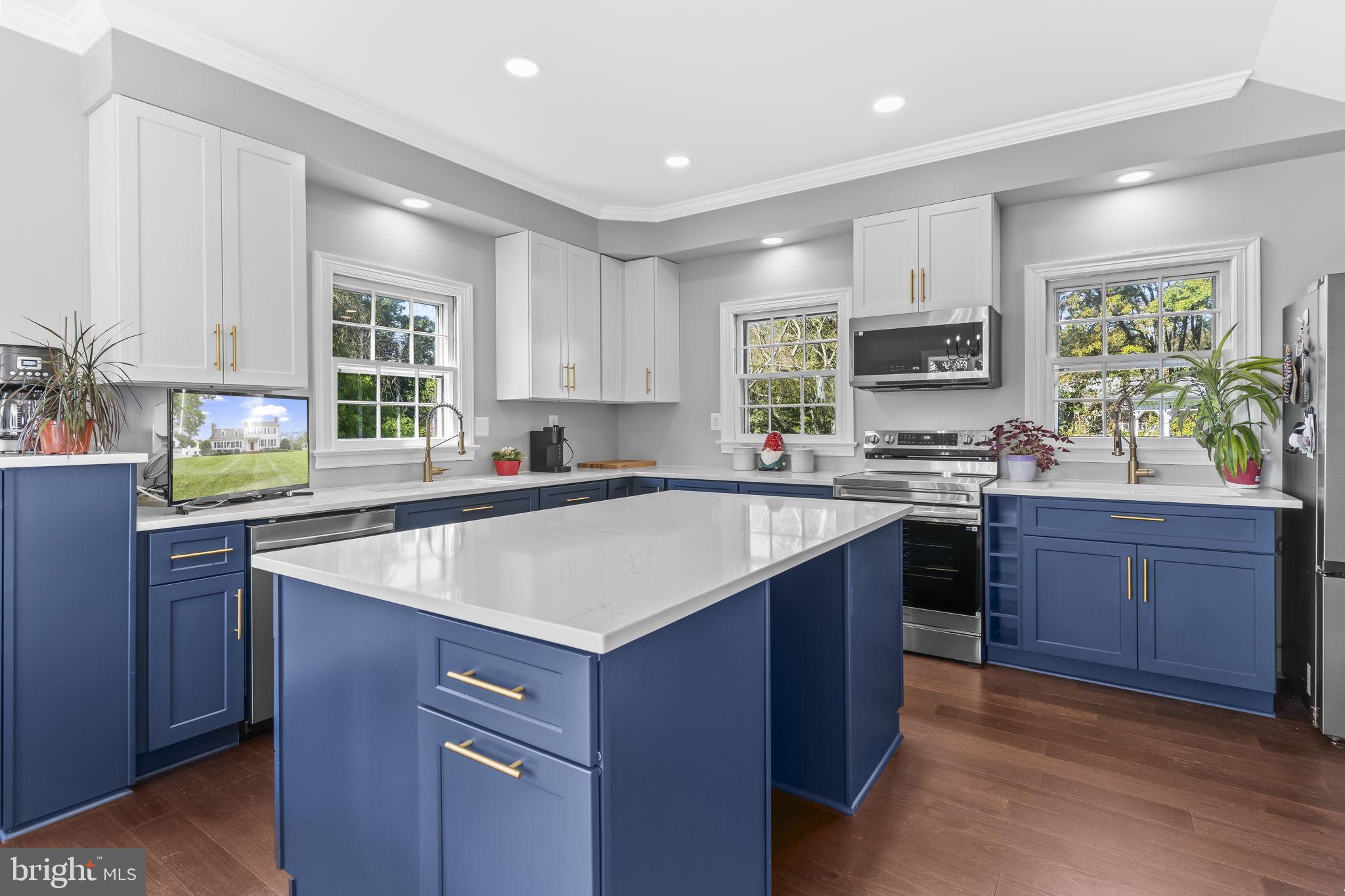 525 Small Reward Road Huntingtown, MD 20639 - Photo 3 of 67 a kitchen with a sink stove top oven and microwave