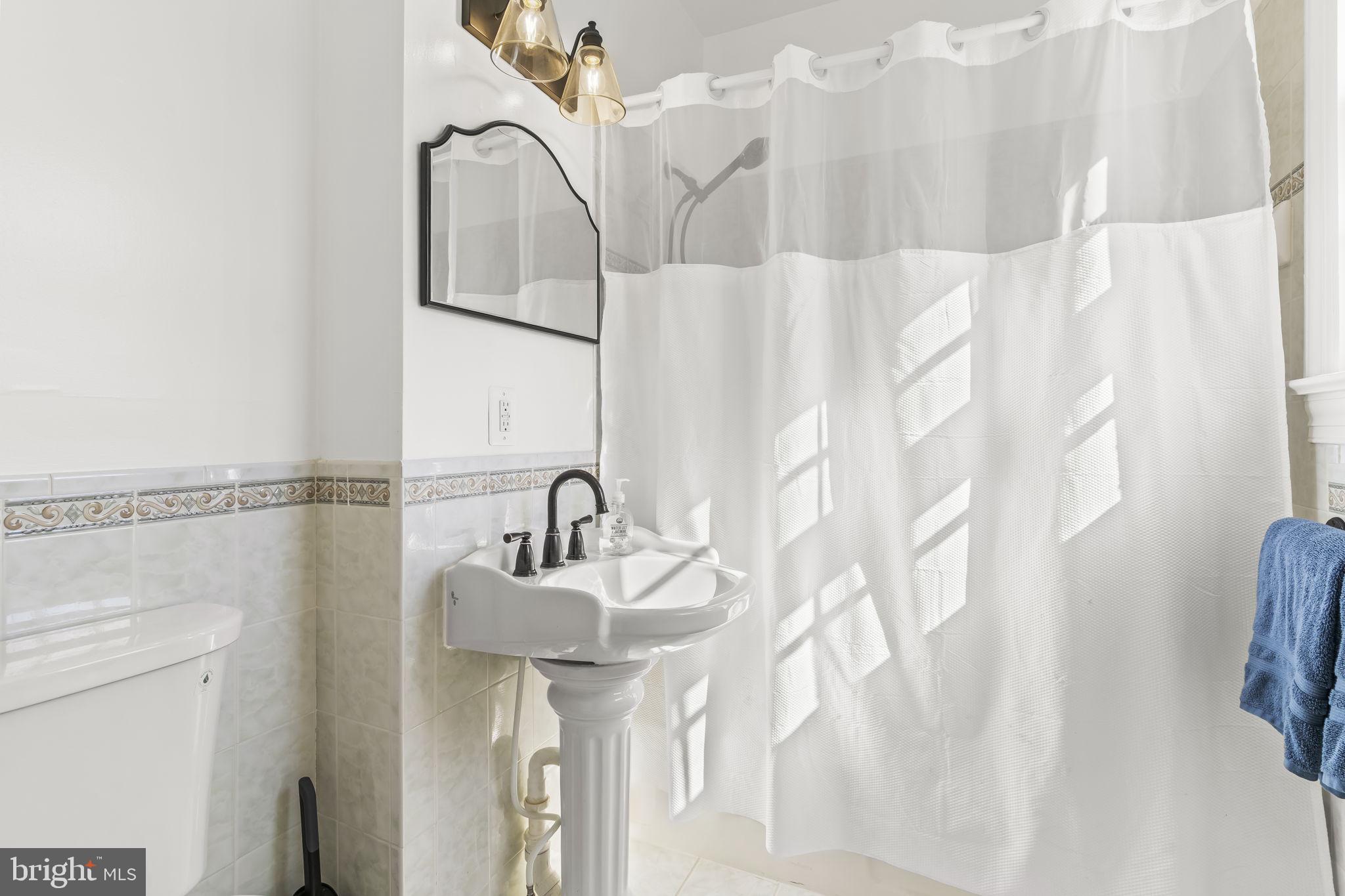 525 Small Reward Road Huntingtown, MD 20639 - Photo 37 of 67 a bathroom with a sink and mirror