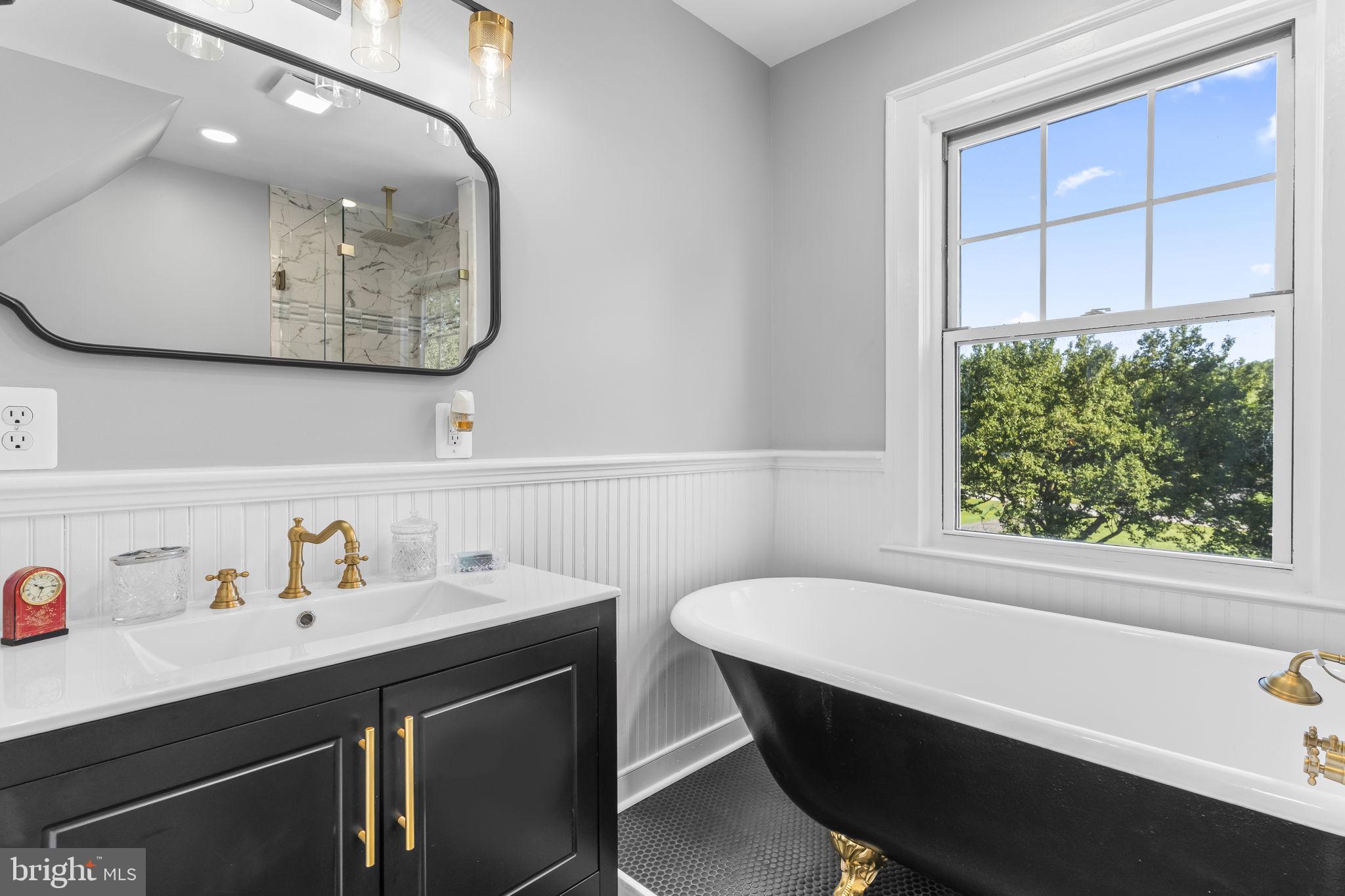 525 Small Reward Road Huntingtown, MD 20639 - Photo 5 of 67 a bathroom with a sink a bathtub and a window
