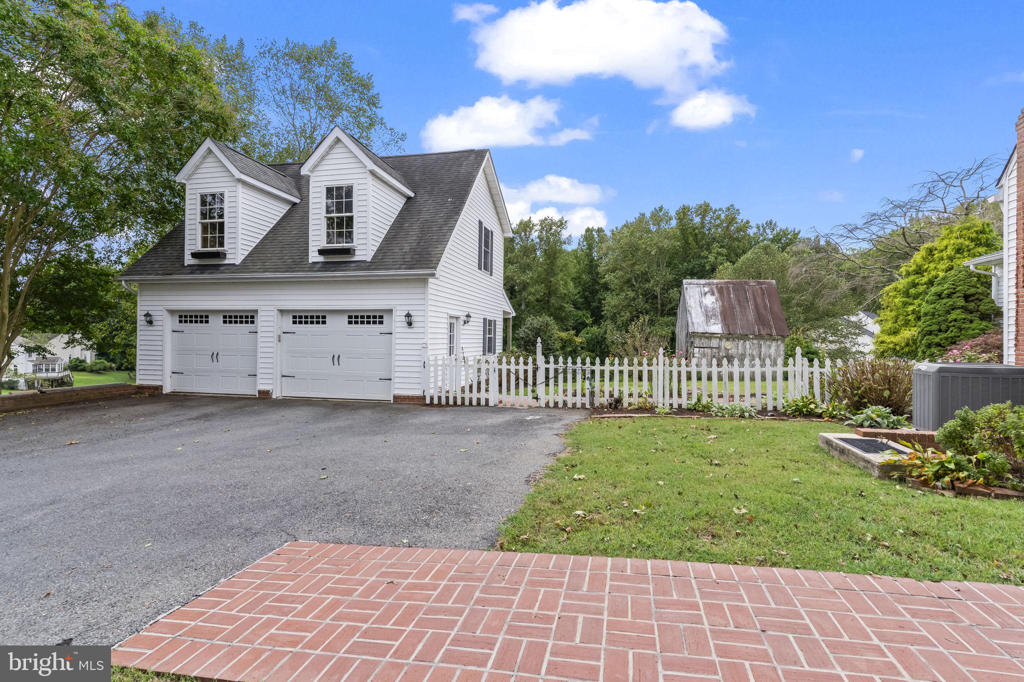 525 Small Reward Road Huntingtown, MD 20639 - Photo 58 of 67 a front view of a house with a yard and garage