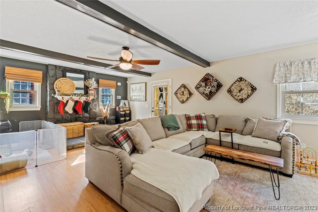 1036 Pendergrass Road Sanford, NC 27330 - Photo 13 of 31 a living room with furniture ceiling fan and a wooden floor