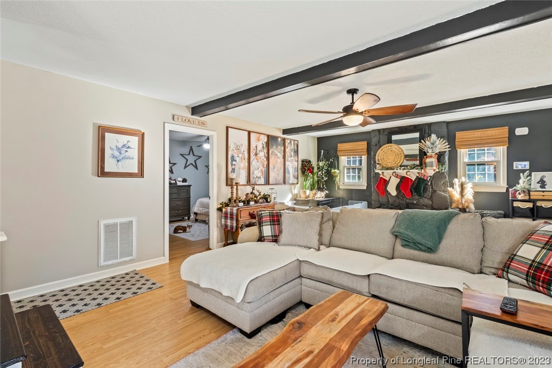 1036 Pendergrass Road Sanford, NC 27330 - Photo 14 of 31 a living room with furniture and a rug