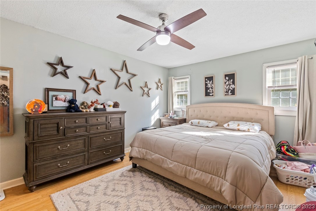 1036 Pendergrass Road Sanford, NC 27330 - Photo 15 of 31 a bedroom with a bed and wooden floor