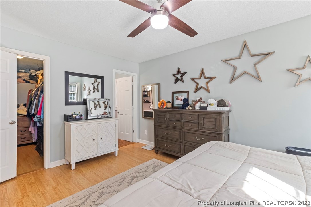 1036 Pendergrass Road Sanford, NC 27330 - Photo 16 of 31 a bed room with a bed and a chandelier