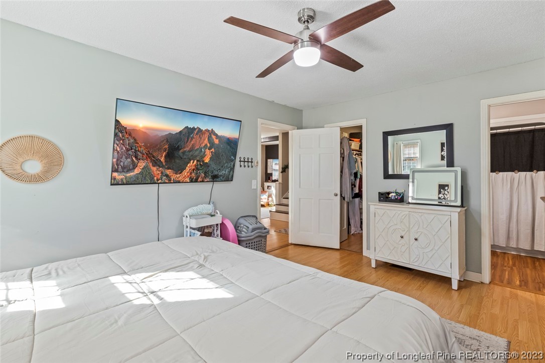 1036 Pendergrass Road Sanford, NC 27330 - Photo 17 of 31 a bedroom with a bed and a chandelier