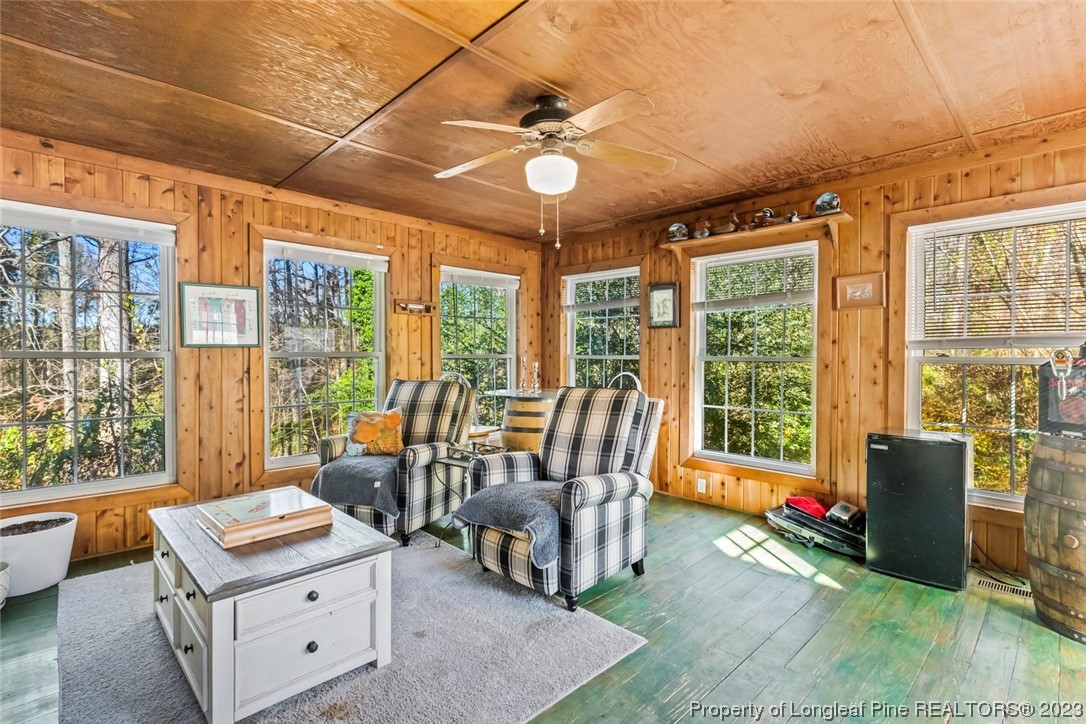 1036 Pendergrass Road Sanford, NC 27330 - Photo 19 of 31 a living room with furniture and a floor to ceiling window