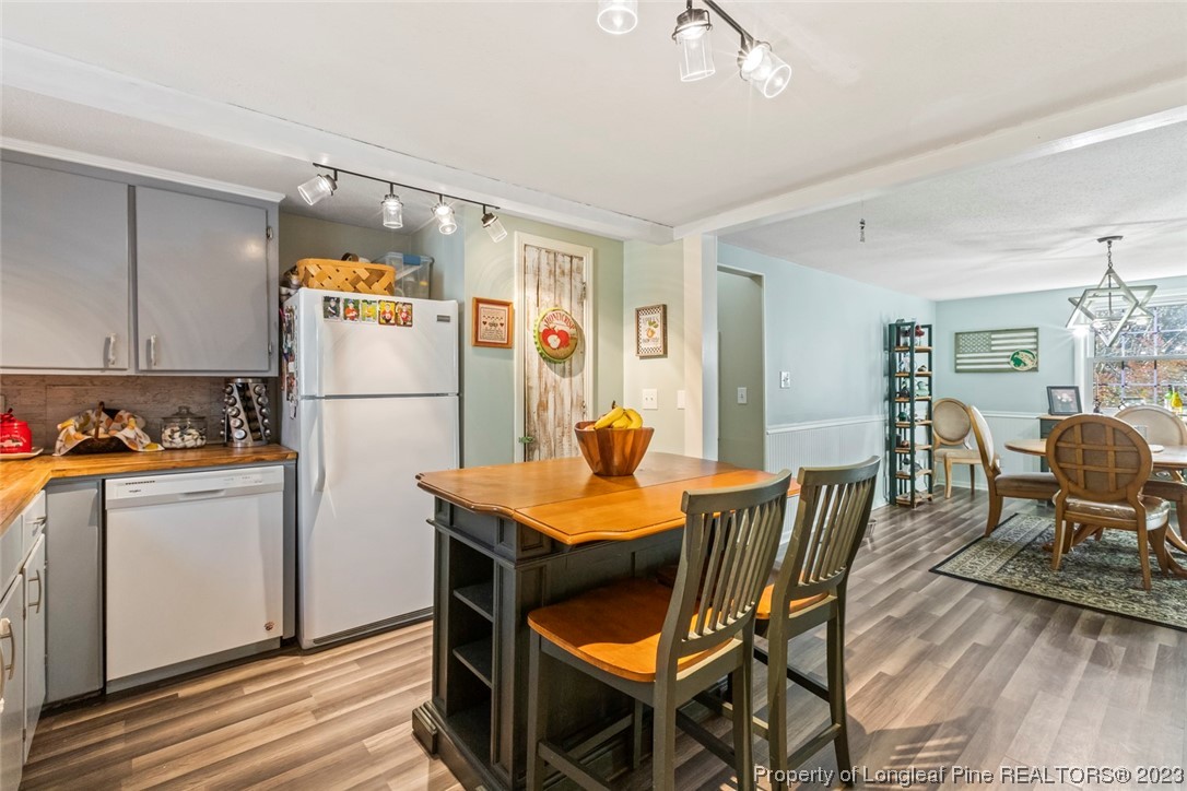 1036 Pendergrass Road Sanford, NC 27330 - Photo 22 of 31 a dining room with furniture a kitchen view and wooden floor