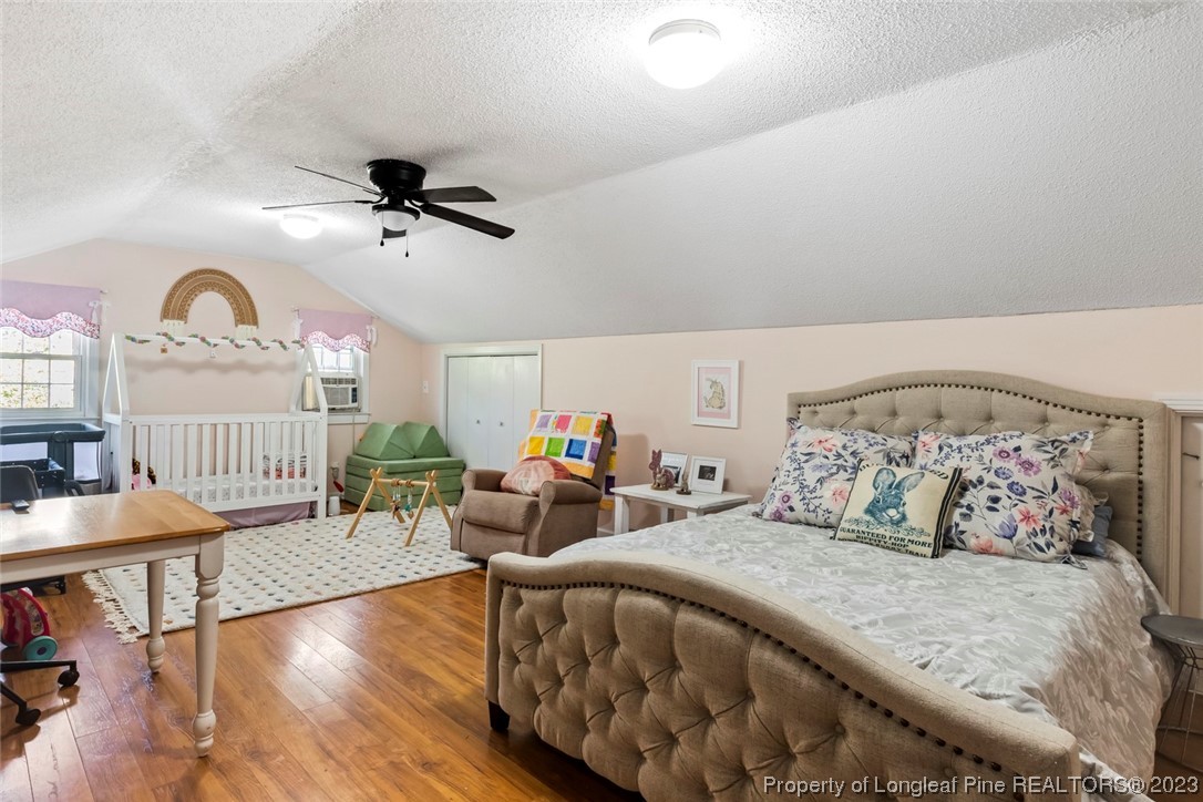 1036 Pendergrass Road Sanford, NC 27330 - Photo 26 of 31 a bedroom with bed and wooden floor