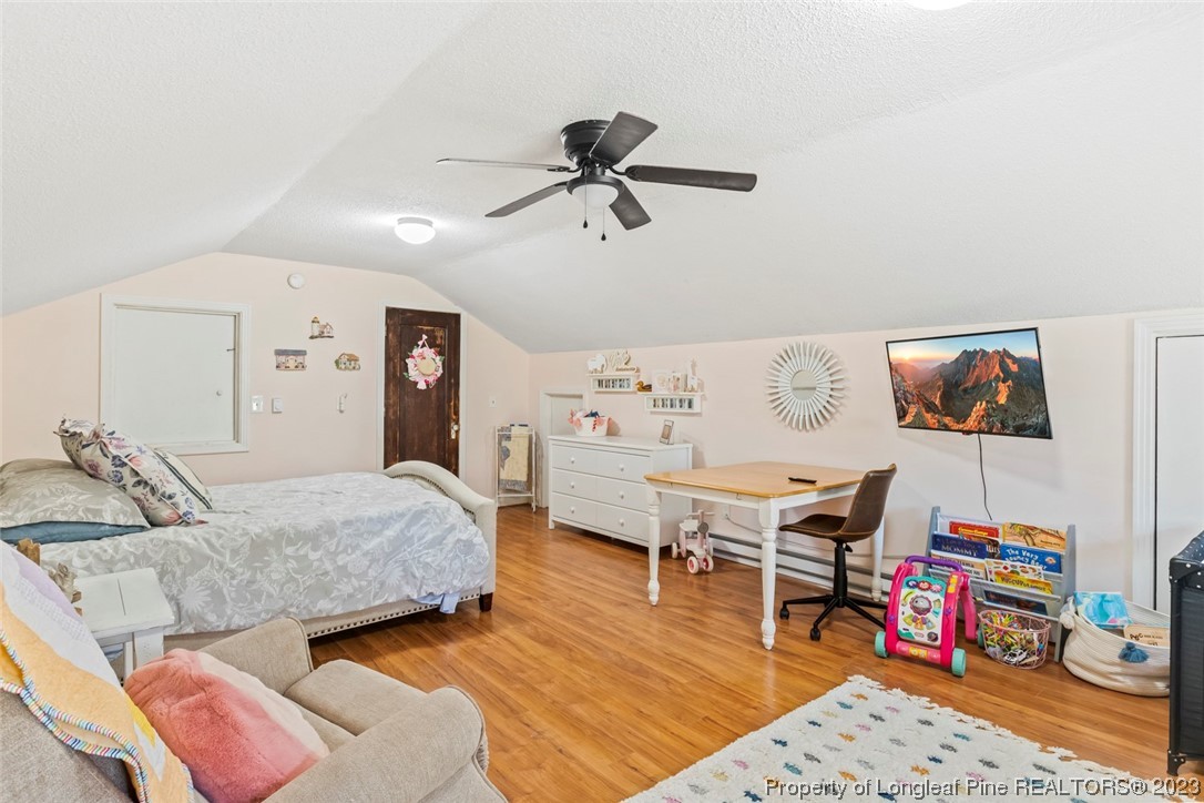 1036 Pendergrass Road Sanford, NC 27330 - Photo 27 of 31 a bedroom with furniture and a wooden floor