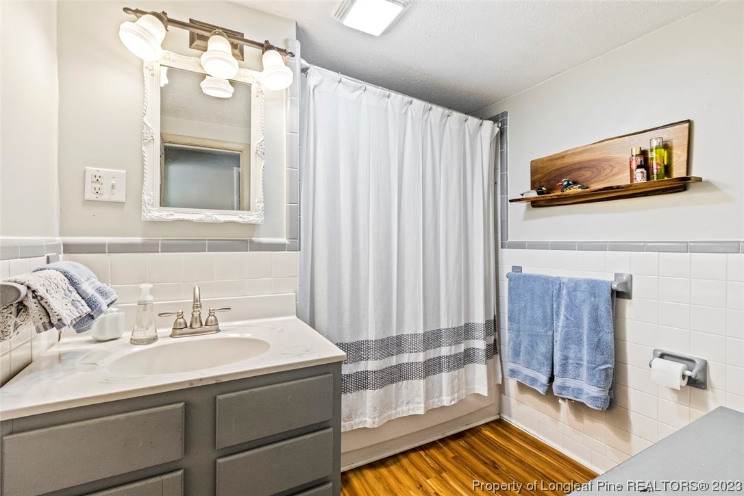 1036 Pendergrass Road Sanford, NC 27330 - Photo 28 of 31 a bathroom with a sink and a mirror