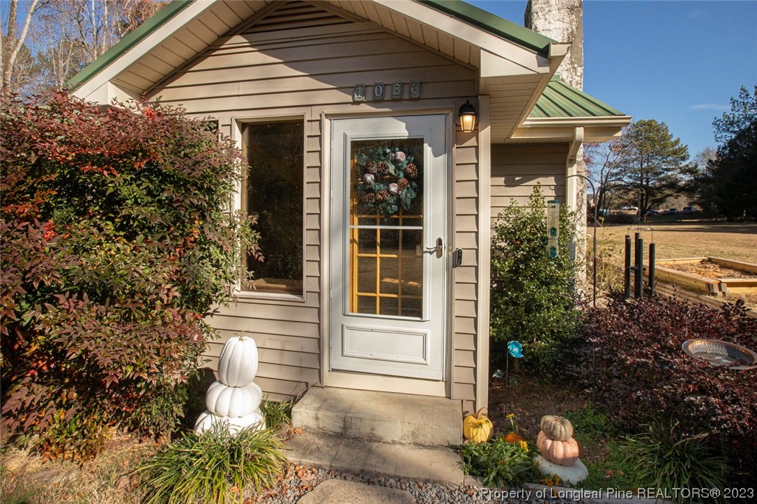 1036 Pendergrass Road Sanford, NC 27330 - Photo 4 of 31 a front view of a house with a yard
