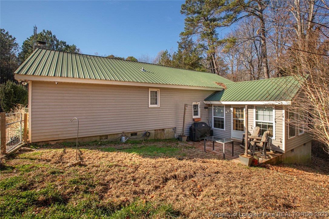 1036 Pendergrass Road Sanford, NC 27330 - Photo 8 of 31 a view of a house with a yard chairs and floor to ceiling window