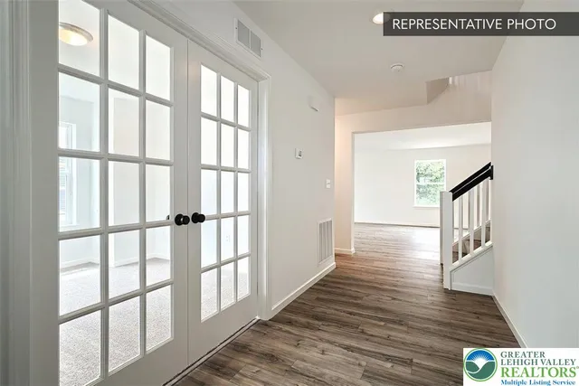 a view of an entryway with wooden floor