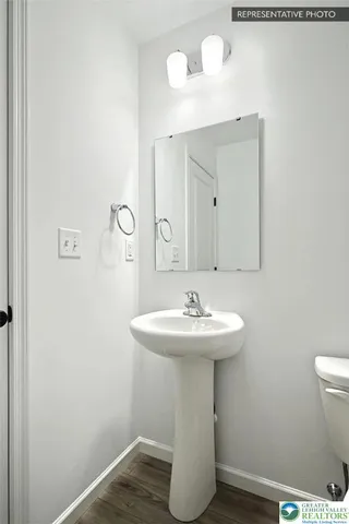a bathroom with a sink toilet and mirror