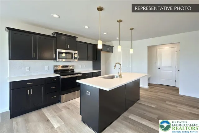 a kitchen with a sink a stove a refrigerator and cabinets