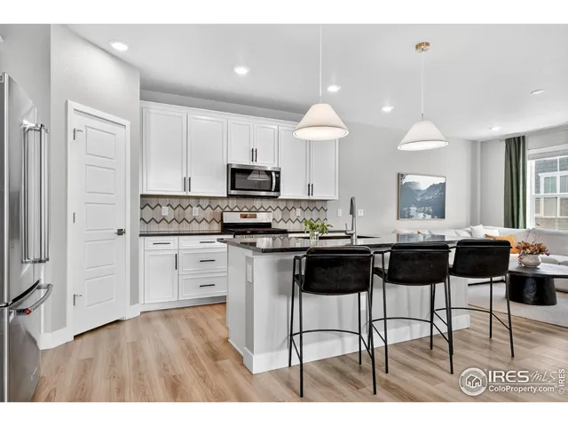 a kitchen with stainless steel appliances kitchen island granite countertop a stove a sink a counter top space and cabinets