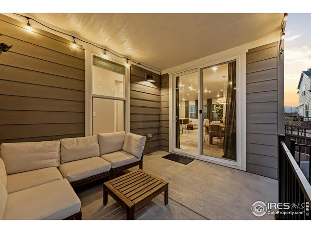 a living room with furniture a rug and white walls