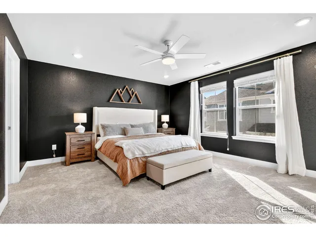 a spacious bedroom with a bed and a large window